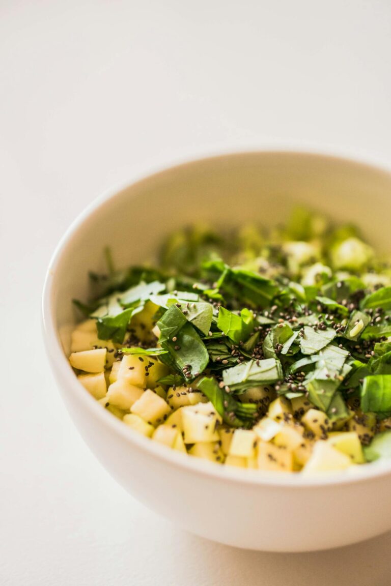 Close-up of diced fruit and herbs creating a vibrant and healthy dish.